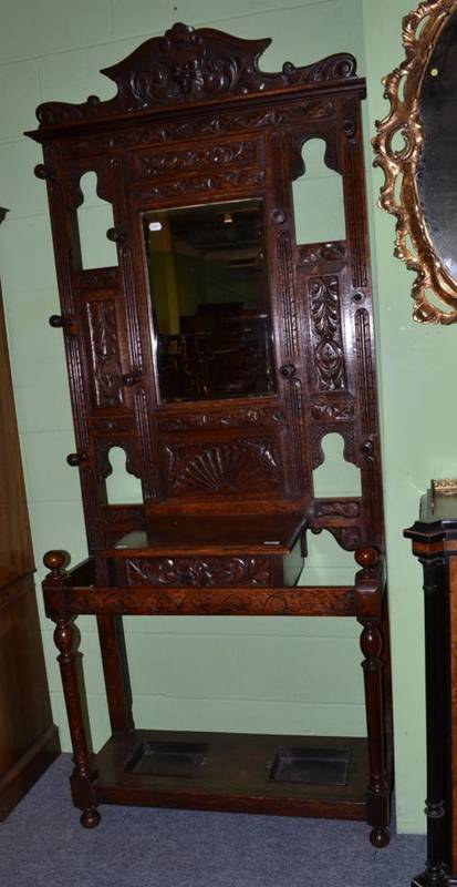 Lot 432 - 19th century oak hall stand, the upper section with bevelled mirror carved with masks, scroll...