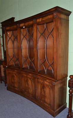 Lot 433 - A reproduction mahogany concave three door bookcase