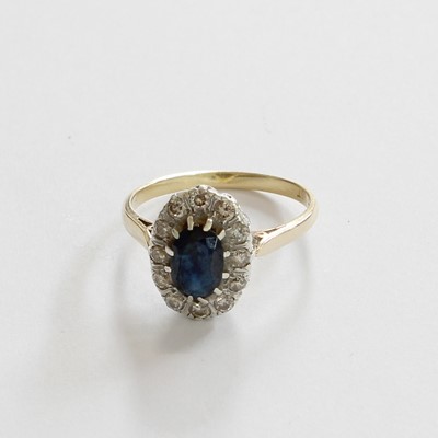 Lot 171 - A Sapphire and Diamond Cluster Ring, the oval...