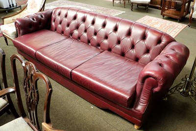 Lot 1331 - A Buttoned Red Leather Three Seater Sofa,...