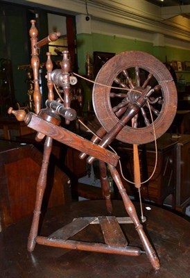Lot 452 - A 19th century turned elm and fruit wood spinning wheel