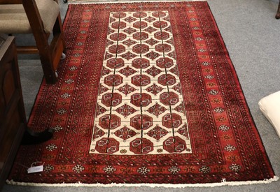 Lot 1152 - "Bukhara" Rug, the camel ground with three...