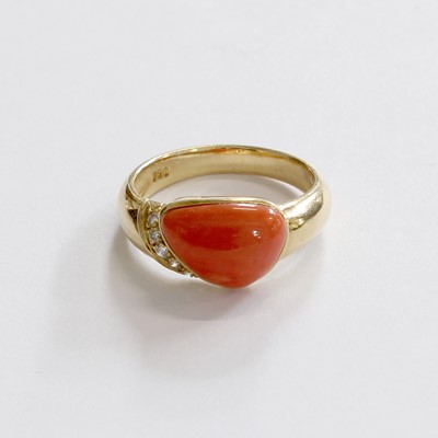 Lot 228 - A Coral and Diamond Ring, the irregular shaped...