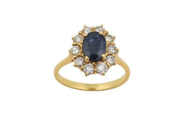 Lot 2384 - A Sapphire and Diamond Cluster Ring the oval...