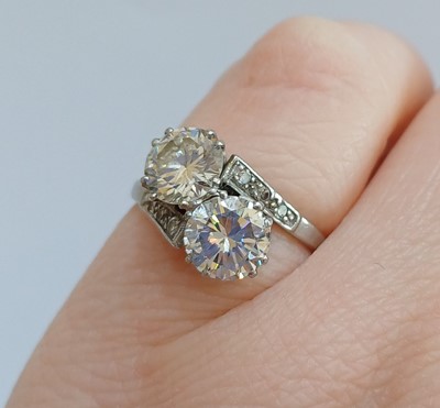 Lot 2192 - A Diamond Two Stone Twist Ring the round...