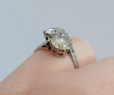Lot 2192 - A Diamond Two Stone Twist Ring the round...