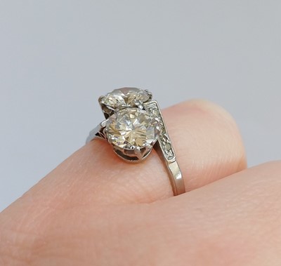Lot 2192 - A Diamond Two Stone Twist Ring the round...
