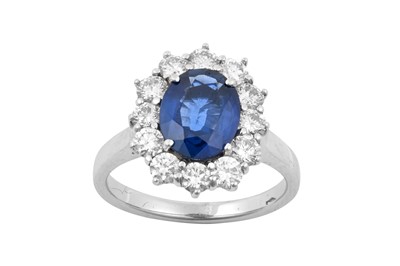 Lot 2307 - A Sapphire and Diamond Cluster Ring the oval...