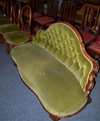 Lot 504 - A late Victorian walnut framed settee and four similar balloon back dining chairs with green velvet