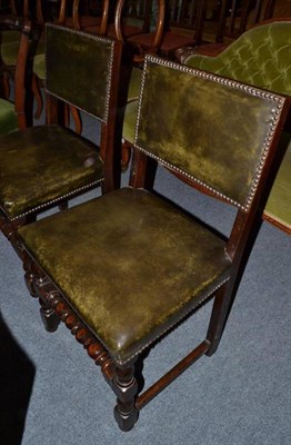 Lot 506 - Two oak framed dining chairs with leather upholstery