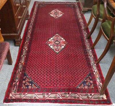 Lot 1182 - Saraband Rug, the blood red field with two...