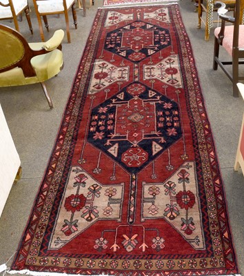 Lot 1119 - Hamadan Runner, the deep brick red field with...