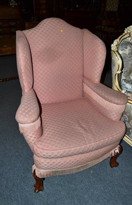 Lot 526 - Pink upholstered wing armchair