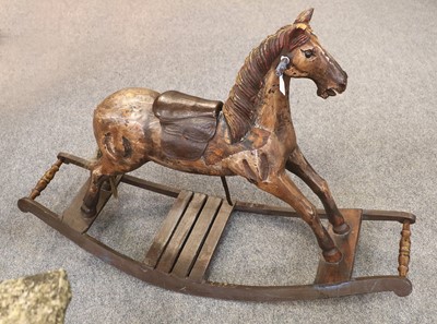 Lot 1375 - A Carved and Painted Small Rocking Horse, on...