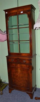 Lot 569 - A reproduction walnut glazed cabinet bookcase