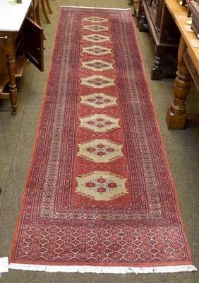 Lot 1144 - "Bukhara" Runner, the brick red field with a...