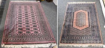 Lot 1081 - "Bukhara" Rug, the lilac field with three...