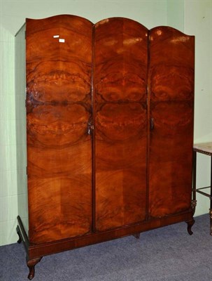 Lot 577 - A walnut triple wardrobe