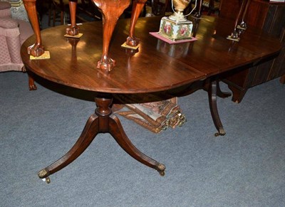 Lot 587 - A mahogany twin pedestal dining table