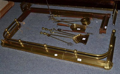 Lot 591 - Three brass fenders, various fire irons, brass chestnut roaster, etc