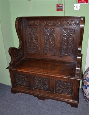 Lot 592 - A carved oak hall bench