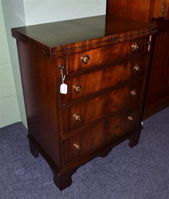 Lot 596 - A reproduction mahogany bachelors chest with fold over top