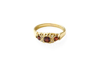 Lot 378 - An 18 Carat Gold Garnet Ring, three graduated...