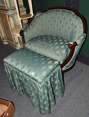 Lot 609 - A French tub chair with carved frame and a footstool with the same upholstery