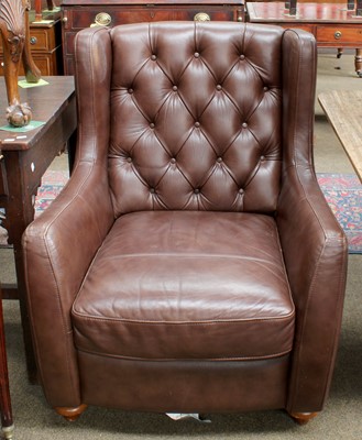 Lot 1283 - A Modern Brown Leather Button Wing Chair