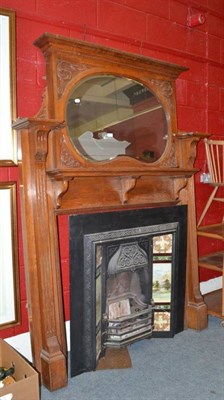 Lot 619 - Oak fire surround and cast iron fireplace