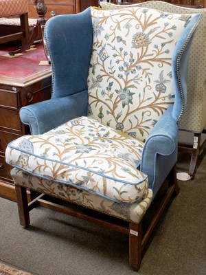 Lot 1234 - A George III Style Wing Back Armchair, with...