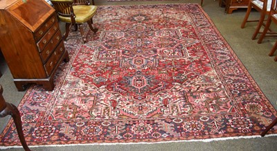 Lot 1169 - Heriz Carpet, the faded raspberry field of...