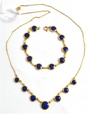 Lot 11 - A lapis lazuli necklace and bracelet, round polished lapis lazuli stones in yellow bezel...