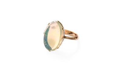 Lot 428 - An Opal Ring, the oval cabochon opal in a...