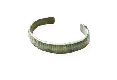 Lot 438 - A Bronze Torque Bangle, with reeded decoration,...