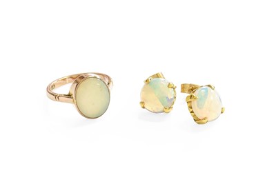 Lot 47 - An Opal Ring, the oval opal in a yellow...