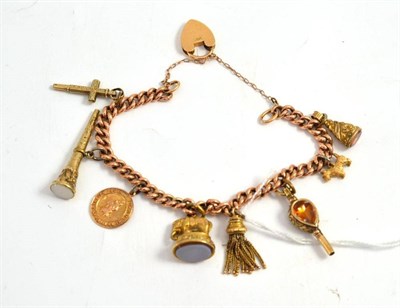 Lot 28 - A charm bracelet hung with eight charms