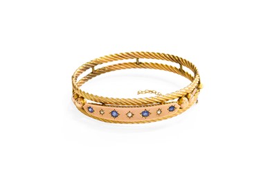 Lot 136 - A 9 Carat Gold Sapphire and Diamond Bangle,...