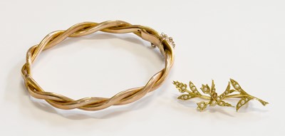 Lot 218 - A Bangle, of textured twist design, stamped '9'...