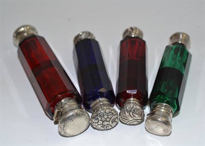Lot 36 - Four Victorian double ended scent bottles with silver coloured mounts and cut glass phials (two...