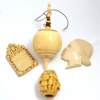 Lot 38 - A European? ivory carving, an ivory spinning top, a head pendent and another carving