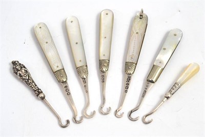Lot 41 - Five silver and mother of pearl folding button hooks and two others
