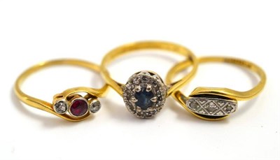 Lot 57 - A ruby and diamond three stone ring, a sapphire and diamond cluster ring and a diamond ring