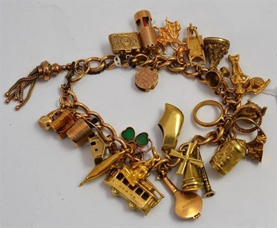 Lot 63 - A charm bracelet, hung with twenty eight charms, some hallmarked, including a flamenco dancer,...