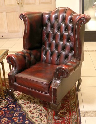 Lot 1427 - A Modern Red Leather Wingback Chair, 81cm by...