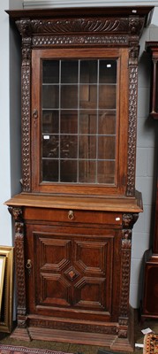 Lot 1264 - A Carved Oak Bookcase, with lion masks, busts...