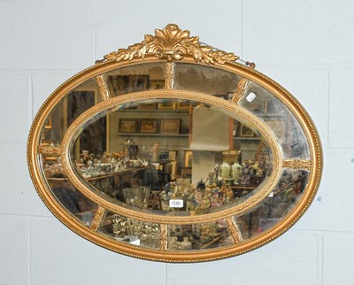 Lot 1140 - A Regency Gilt Framed Sectional Mirror, oval...