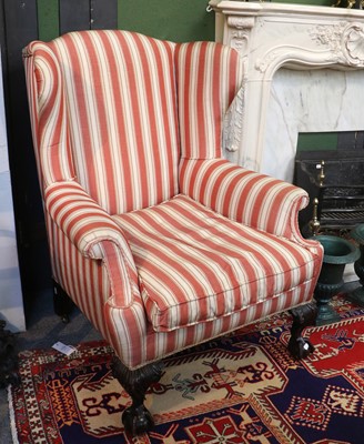 Lot 1433 - A Georgian Style Wingback Armchair, with...