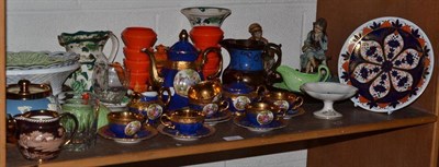 Lot 130 - Shelf of decorative ceramics including a Derby plate, Continental blue and gilt tea service, copper