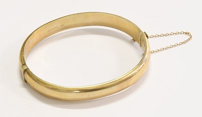 Lot 256 - A 9 Carat Gold Hinged Bangle, with engraved...